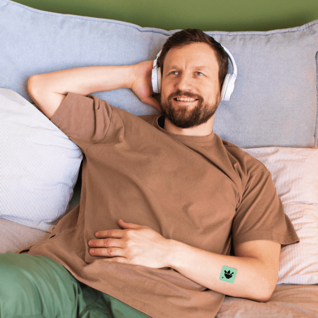 Man relaxing while wearing a Klova Micronutrient Patch on his arm